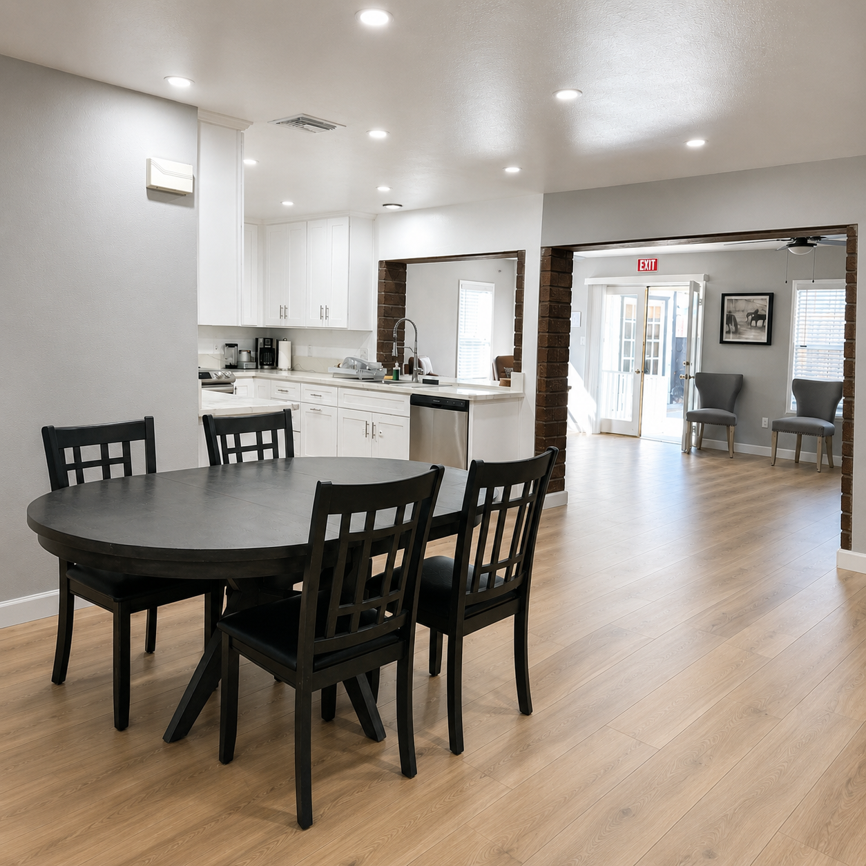 427901ab-8c94-4508-9740-9276c417e09e Bright shared dining and kitchen area in a senior living home with open seating and modern finishes.